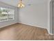 Dining room with wood-look flooring and a large window at 423 Courtland Ct, Kannapolis, NC 28081