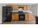 Well-equipped kitchen showcasing black appliances, wood cabinets and countertops for everyday cooking convenience and style at 423 Courtland Ct, Kannapolis, NC 28081