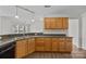 Bright kitchen features wood cabinets, stainless steel sink, and black appliances, perfect for cooking and entertaining at 423 Courtland Ct, Kannapolis, NC 28081
