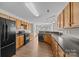 Spacious kitchen boasts hardwood floors, wood cabinets, and modern black appliances, creating an inviting culinary space at 423 Courtland Ct, Kannapolis, NC 28081