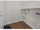 Laundry room features overhead wire shelf for storage and wood look flooring at 423 Courtland Ct, Kannapolis, NC 28081