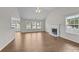Bright living room with a fireplace, wood-look floors, and many windows at 423 Courtland Ct, Kannapolis, NC 28081