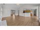 Open floor plan with wood-look flooring, fireplace and view of the kitchen at 423 Courtland Ct, Kannapolis, NC 28081