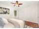 Bright bedroom features a ceiling fan, wood floors, and natural light from the window at 4329 Hathaway St # D, Charlotte, NC 28211