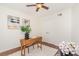 Bedroom featuring a desk with hardwood floors, a ceiling fan, and ample closet space at 4329 Hathaway St # D, Charlotte, NC 28211