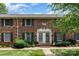 Brick townhouse with black shutters and landscaping, featuring dual front doors at 4329 Hathaway St # D, Charlotte, NC 28211