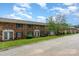 Brick townhouse complex with well-maintained landscaping and a paved road at 4329 Hathaway St # D, Charlotte, NC 28211