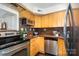 Efficient kitchen with stainless steel appliances, granite countertops, and maple cabinets at 4329 Hathaway St # D, Charlotte, NC 28211