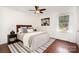 Calm bedroom with hardwood floors, neutral decor, ceiling fan, and natural light at 4329 Hathaway St # D, Charlotte, NC 28211