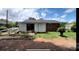 View of backyard with white siding, brick exterior, partial shed and luscious green grass at 4414 Birkdale Dr, Charlotte, NC 28208