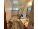 Cozy bathroom featuring a toilet, vanity, sink, mirror and shower-tub combination with patterned tile and fixtures at 4414 Birkdale Dr, Charlotte, NC 28208