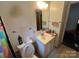 Cozy bathroom featuring a toilet, vanity, sink, mirror and shower-tub combination with patterned tile and fixtures at 4414 Birkdale Dr, Charlotte, NC 28208