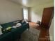 Bedroom with hardwood floors, window, and neutral paint at 4414 Birkdale Dr, Charlotte, NC 28208