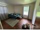 Modest bedroom with hardwood floors, complemented by a window for natural light and a decorative area rug at 4414 Birkdale Dr, Charlotte, NC 28208