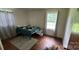 Modest bedroom with hardwood floors, complemented by a window for natural light and a decorative area rug at 4414 Birkdale Dr, Charlotte, NC 28208
