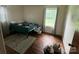 Bedroom with hardwood floors, window, and neutral paint at 4414 Birkdale Dr, Charlotte, NC 28208