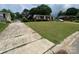 A charming brick home sits on a well-maintained lot with a detached two-car garage and long driveway at 4414 Birkdale Dr, Charlotte, NC 28208