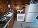 Vintage kitchen featuring wood paneling, appliances, and linoleum flooring at 4414 Birkdale Dr, Charlotte, NC 28208