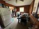 Eat-in kitchen featuring wood paneling, appliances, and linoleum flooring at 4414 Birkdale Dr, Charlotte, NC 28208