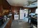 Eat-in kitchen featuring wood paneling, appliances, and linoleum flooring at 4414 Birkdale Dr, Charlotte, NC 28208
