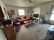 Cozy living room with a ceiling fan, vintage furnishings, and natural light at 4414 Birkdale Dr, Charlotte, NC 28208