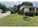 View of side yard with brick exterior, partial shed and luscious green grass at 4414 Birkdale Dr, Charlotte, NC 28208