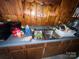 Vintage kitchen featuring wood paneling, sink, and laminate countertops at 4414 Birkdale Dr, Charlotte, NC 28208