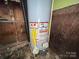 A close up of a new hot water heater with yellow gas line at 4414 Birkdale Dr, Charlotte, NC 28208