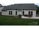 Back of house with a covered patio, grill, manicured lawn and cactus garden at 4711 Lenox Hill Pl # 98, Charlotte, NC 28269