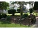 Landscaped backyard featuring mature trees, manicured lawn and stately lion statue at 4711 Lenox Hill Pl # 98, Charlotte, NC 28269
