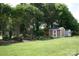 Backyard featuring mature trees, landscaping, lawn and storage shed at 4711 Lenox Hill Pl # 98, Charlotte, NC 28269