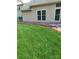 Backyard showing well-manicured lawn with flowers and landscaping along the house at 4711 Lenox Hill Pl # 98, Charlotte, NC 28269