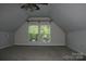 Unfurnished bonus room with carpeted floor, windows, and a ceiling fan with lighting at 4711 Lenox Hill Pl # 98, Charlotte, NC 28269