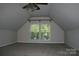 Empty bonus room with large windows, carpeted floors, and a ceiling fan with lighting at 4711 Lenox Hill Pl # 98, Charlotte, NC 28269