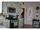 Well-lit kitchen featuring stainless steel appliances, modern backsplash, and light green cabinets at 4711 Lenox Hill Pl # 98, Charlotte, NC 28269