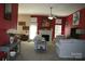 View of the living room featuring a fireplace, neutral furniture, ceiling fan and decorative items at 4711 Lenox Hill Pl # 98, Charlotte, NC 28269