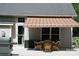 Covered patio with wicker furniture and grill at 4711 Lenox Hill Pl # 98, Charlotte, NC 28269