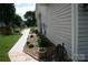 Landscaped side yard featuring a walkway, mulch and a variety of plants at 4711 Lenox Hill Pl # 98, Charlotte, NC 28269