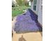 Beautifully landscaped side yard with flowering ground cover, walkway and decorative plants at 4711 Lenox Hill Pl # 98, Charlotte, NC 28269