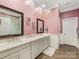 Bathroom boasts double vanity, grey cabinetry, and decorative mirrors at 5030 Waldron Meadow Dr, Charlotte, NC 28226