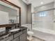 Modern bathroom featuring a glass-enclosed tub-shower, granite countertop, and stylish fixtures at 5030 Waldron Meadow Dr, Charlotte, NC 28226