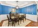 Cozy dining area featuring hardwood floors, modern lighting, and blue accent walls at 5030 Waldron Meadow Dr, Charlotte, NC 28226