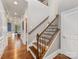 Spacious hallway with hardwood floors and a staircase, leading to the dining room at 5030 Waldron Meadow Dr, Charlotte, NC 28226