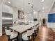 Bright kitchen features a large center island with a granite countertop and seating for four at 5030 Waldron Meadow Dr, Charlotte, NC 28226