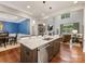 Open concept kitchen features an island with seating overlooking the living room at 5030 Waldron Meadow Dr, Charlotte, NC 28226