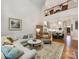 Open concept living room with hardwood floors adjacent to kitchen and staircase overlooking the living space at 5030 Waldron Meadow Dr, Charlotte, NC 28226