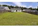 Spacious backyard with lush grass and wood fencing around property at 5523 Stone Bluff Ct, Charlotte, NC 28214