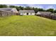 Spacious backyard with lush grass and wood fencing around property at 5523 Stone Bluff Ct, Charlotte, NC 28214