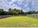 A large, lush backyard features a wood fence at 5523 Stone Bluff Ct, Charlotte, NC 28214