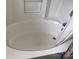 A large, white bathtub features a tile surround at 5523 Stone Bluff Ct, Charlotte, NC 28214